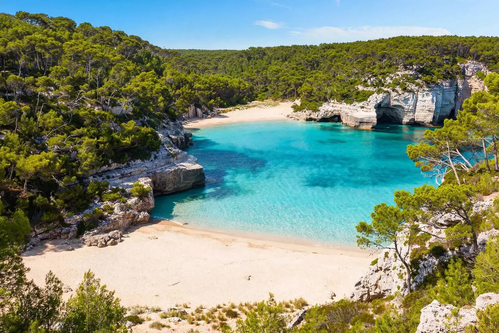 Turquoise cove with white sand in Menorca, Balearic Islands beach Spain