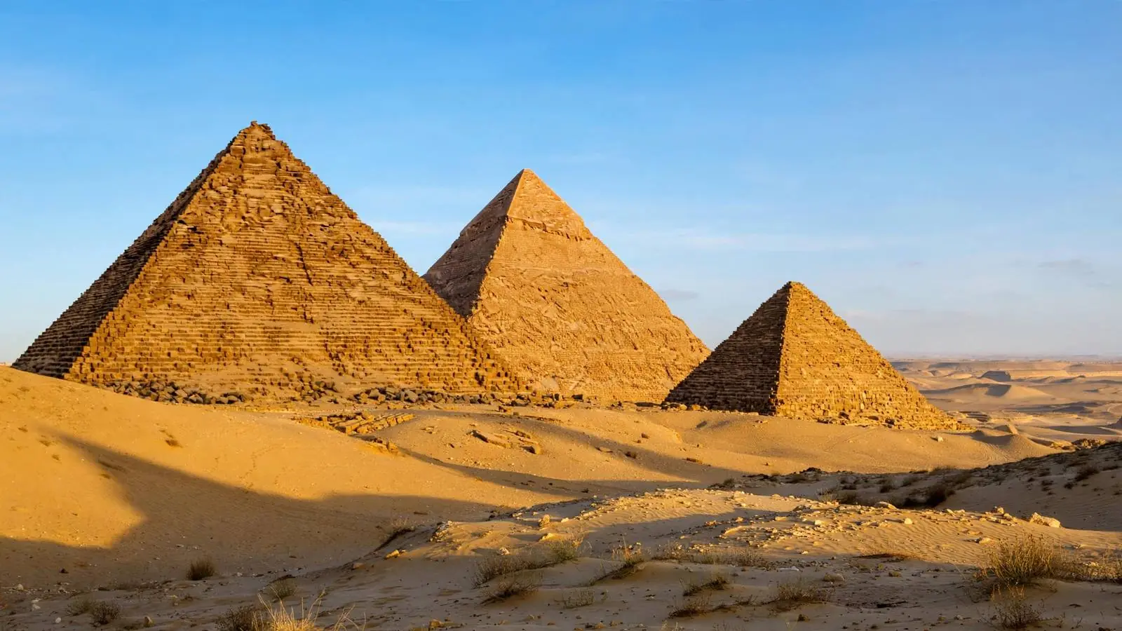 Pyramids of Giza at golden hour with warm desert light