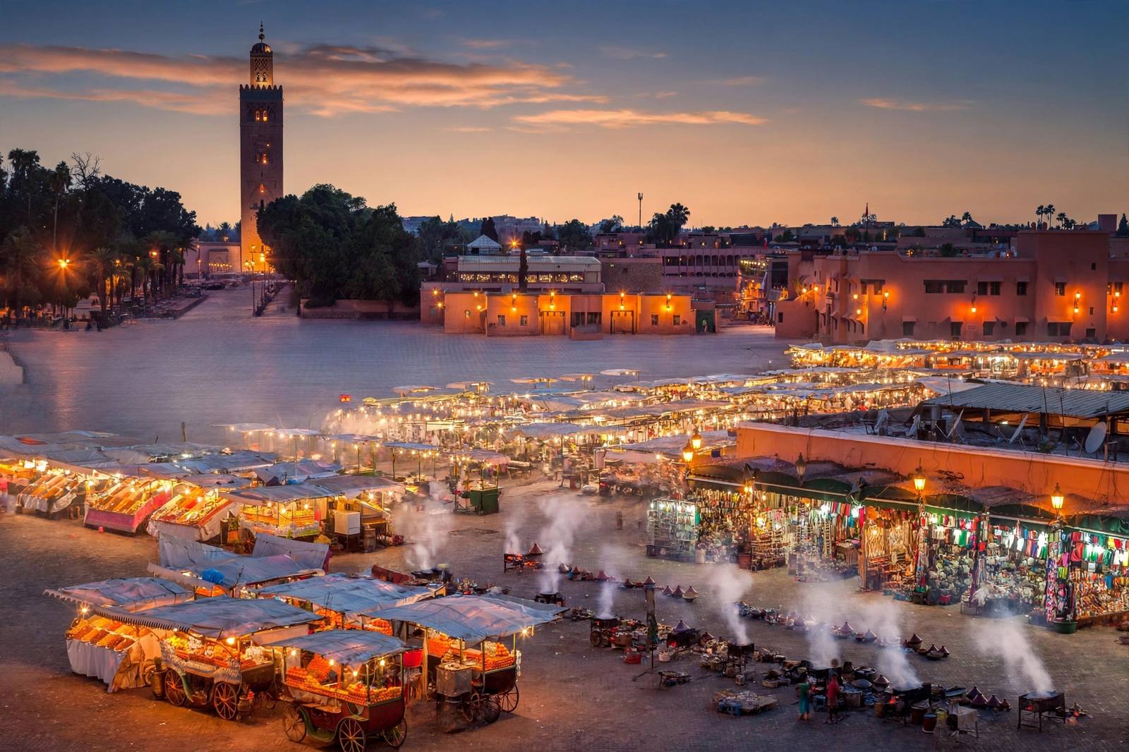 Jemaa el-Fna square at dusk with food stalls and Koutoubia minaret